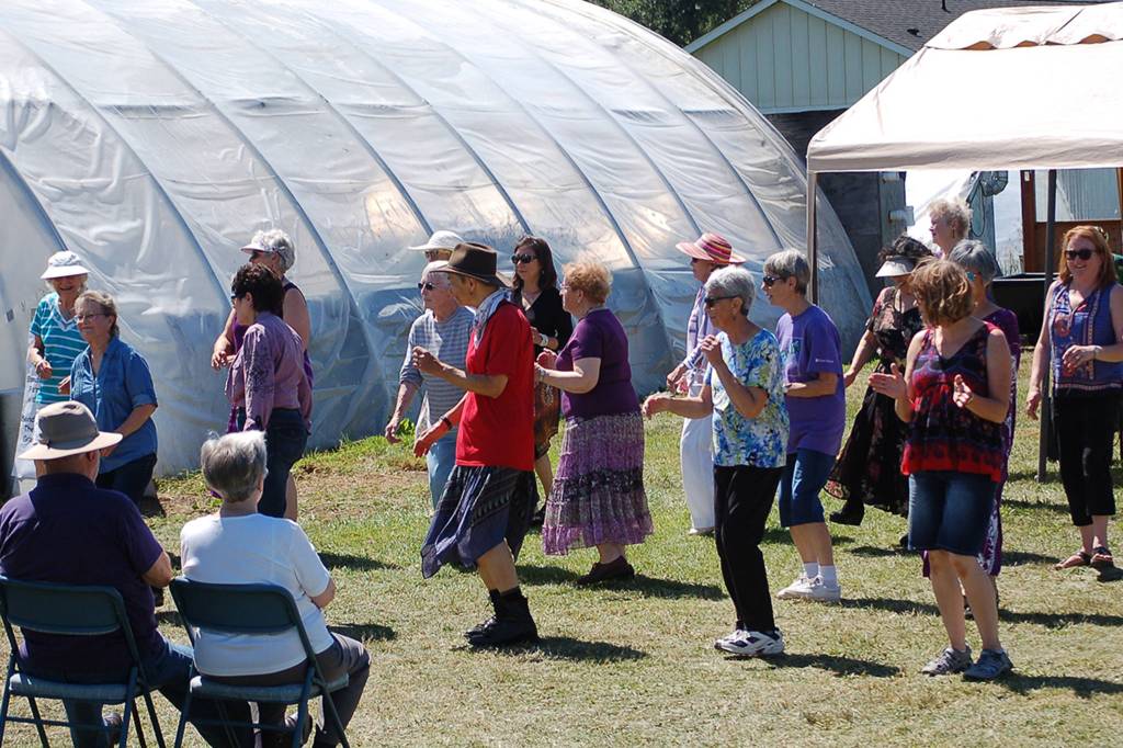 A group of visitors learns a line dance during a Lavender Festival event at Victors Lavender. Sequim Gazette photo by Conor Dowley.