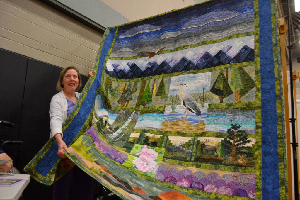 Harriet Freeman of Sequim bought a handful of raffle tickets and came away with the Sunbonnet Sue Quilt Clubs annual raffle quilt to benefit the clubs various community programs. Organizers said they sold at least $6,000 in tickets for Northwest Splendor. It took one-and-a-half years to make from the efforts by quilters Sue Nylander, Carolyn Abbott, Catherine Bilyard, Anne Davies, Sherry Nagel, Liisa Fagerland, Ilse Osier, Nancy Wilcox, Mary Ann Clayton, Janet Green, Carol Geer, and quilter by Brianne Moore. Sequim Gazette photo by Matthew Nash