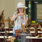 Wendy Boyd of Sequim snaps some shots of art at the 11th annual Olympic Driftwood Sculptors show on July 21. Boyd said she hopes the show helps give her an idea of what to do with some of the driftwood she sees while walking on the beach. Sequim Gazette photo by Matthew Nash