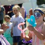 At the Sequim Lavender Festival Street Fair, Shannon Olsen, 8, of Port Orchard, takes a balloon monkey she got from Lily the Fairy at the Chelle Beautiful of Bellingham booth. Shannon said she also got a galaxy fox painted on her face, too. Sequim Gazette photo by Matthew Nash