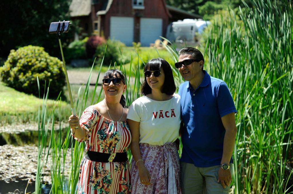 Cynthia Pichardo of Seattle, center, takes a selfie with her mom and dad Leticia Cruz and Jose Luis Pichardo of Mexico City. It was the trios first time in Sequim because they wanted to experience lavender fields, they said. Sequim Gazette photo by Matthew Nash