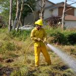 Jack Hueter, firefighter/paramedic with Clallam County Fire District 3, helps extinguish a brush fire on July 19. Sequim Gazette photos by Matthew Nash