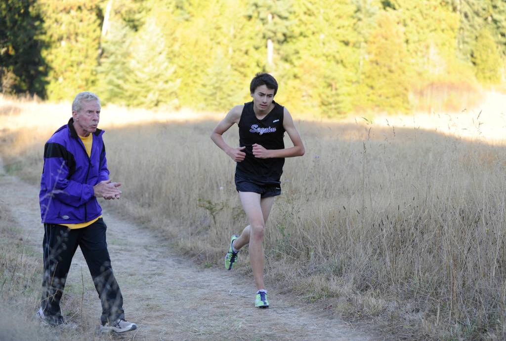 Harold Huff encourages Alex Barry in an Olympic League meet in 2012. Sequim Gazette file photo by Michael Dashiell
