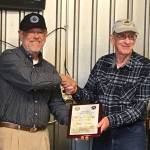 Barry J. Halsted, right, receives the Wright Brothers Master Pilot Award from Ray Ballantyne, representing the FAA Northwest Mountain Flight Standards Division, at the Sequim Valley EAA Chapter 430 monthly gathering on July 27. Submitted photo