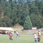 Members of the North Kitsap Force (white shirts) and Franklin Pierce Raptors (red shirts) boys U15 teams track a high ball during their match on Aug. 3 in the Dungeness Cup. North Kitsap eventually won the match 5-0 and finished fourth in their group. Sequim Gazette photo by Conor Dowley.