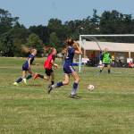 Storm King girls U14 defenders (blue shirts) get back to defend a counter-attack from Harbor Youth Soccer attackers (red vest). Storm King went on to win that match 5-0, and ultimately won the division championship in a 3-1 win over the Tracyton Force. Sequim Gazette photo by Conor Dowley.