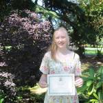 Hannah Gloor accepts a certificate from the Sequim Prairie Garden Club at Pioneer Memorial Park earlier this week. Gloor is considering a career involving architecture and botany. Sequim Gazette photo by Michael Dashiell