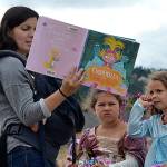 Jamie Brocklesby reads Cinderella and the furry slippers to Josie Bassett, 4, and Jenna Brocklesby, 5, after Princess Storytime on Aug. 1. Sequim Gazette photo by Matthew Nash