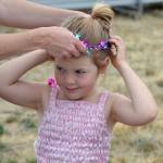 Azlyn Blessington, 4, gets help from her mom Carolyn Raleigh to put on her new crown dressed as a fairy princess at the Princess Storytime. Sequim Gazette photo by Matthew Nash