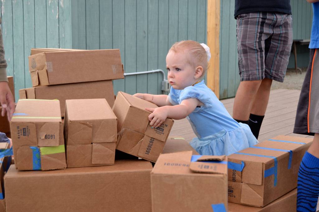 Mia Smith, 18 months, dressed as Cinderella looks to build a castle during Princess Storytime at the Sequim Librarys Summer Reading Program. Sequim Gazette photo by Matthew Nash