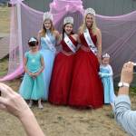 Sequim Irrigation Festival royalty, from left, Queen Emily Silva, Princess Kjirstin Foresman, and Princess Emily Silva stand together for a photo with Savannah Fuller, 3, on right, and Emma Morris, 7, on left. The royalty posed for photos after reading to a large group of princes and princesses on Aug. 1. Sequim Gazette photos by Matthew Nash