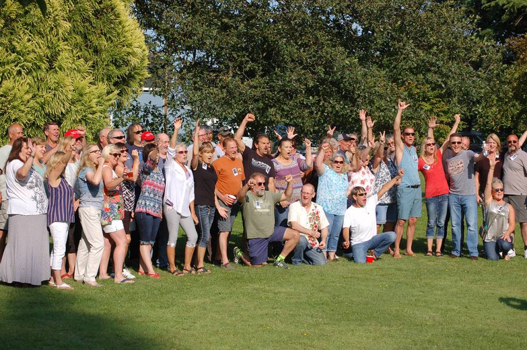 The Sequim High School class of 1979 cheer for a group picture at their 40 year reunion at Pioneer Park on Aug. 3. Sequim Gazette photos by Conor Dowley.