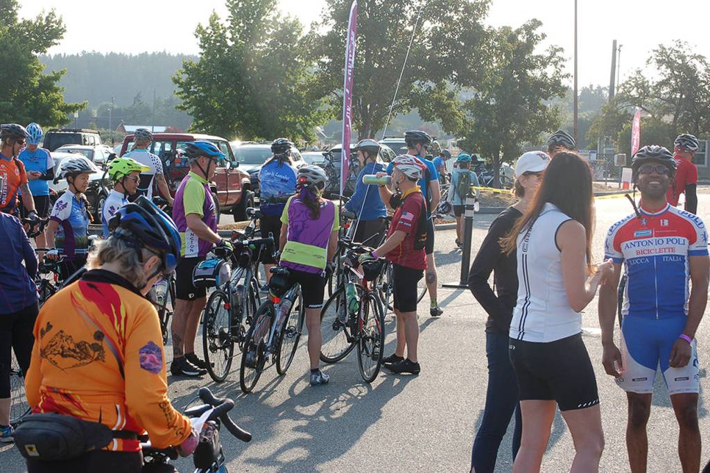 Some of the first riders of the day gather at around 7:30 in the morning and get ready to depart on the Tour de Lavender, which would see riders visit upwards of ten different farms before eventually ending up at Purple Haze for an after party in the evening. Sequim Gazette photo by Conor Dowley.