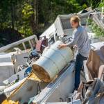 A man, who declined to provide his name, searches through Midway Metals for a fuel drum on Aug. 5. Clallam County is exploring ways to have the property cleaned up. Photo by Jesse Major/Peninsula Daily News
