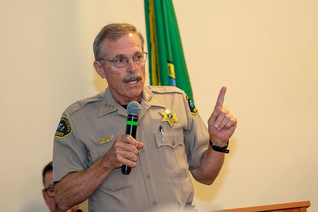 Clallam County Sheriff Bill Benedict tells the crowd at the Jamestown SKlallam Tribes town hall meeting last week that he visited the facility the tribes proposed medication-assisted treatment center is modeled after. (Jesse Major/Peninsula Daily News)