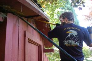 Eagle Scout candidate Ian Thill, back, and Dylan Washburn, front, lift up the first section of the Pioneer Memorial Park storage shed roof as part of Thills Eagle Scout project. This roof was in worse shape than we thought, Thill said.