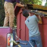 Eagle Scout candidate Ian Thill and Sergio Yanez work on removing a section of the lower roof of the Pioneer Memorial Park storage shed. Sequim Gazette photos by Conor Dowley