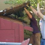 Eagle Scout candidate Ian Thill, back, and Dylan Washburn, front, lift up the first section of the Pioneer Memorial Park storage shed roof as part of Thills Eagle Scout project. This roof was in worse shape than we thought, Thill said partway through the process, remarking that hed been hoping to save some of the support beams. In the end, they had to remove them all because of rot and other degradation. Sequim Gazette photo by Conor Dowley