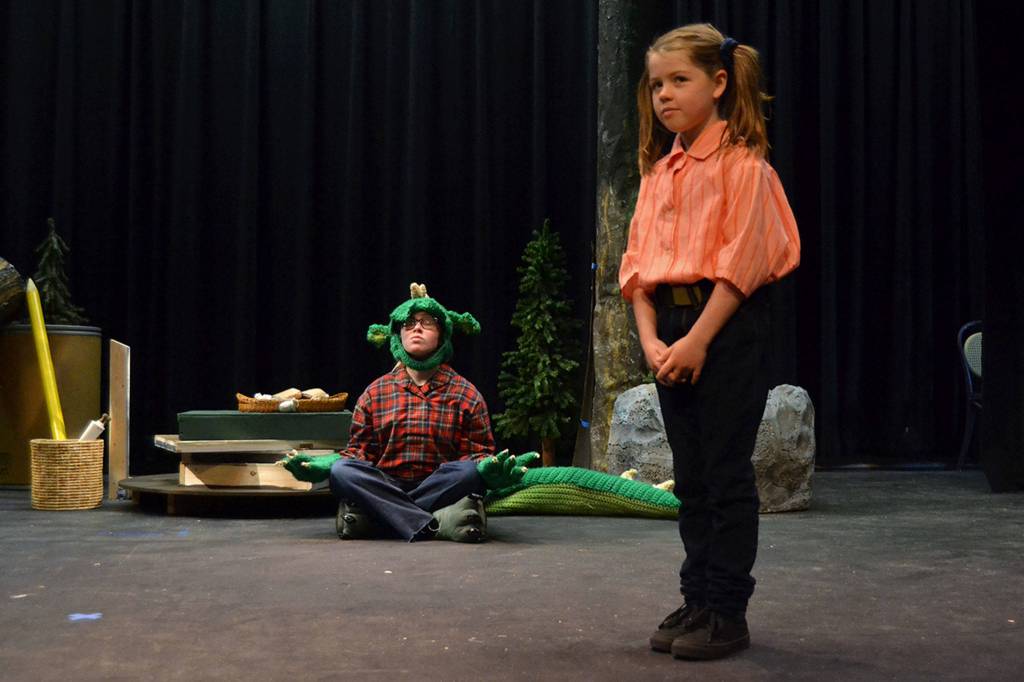 Fred the Dragon (Grayce Houle) prefers yoga over controversy as Charity (Maia Brewer) tries to convince him that the towns people might hurt him in The Reluctant Dragon. Sequim Gazette photo by Matthew Nash