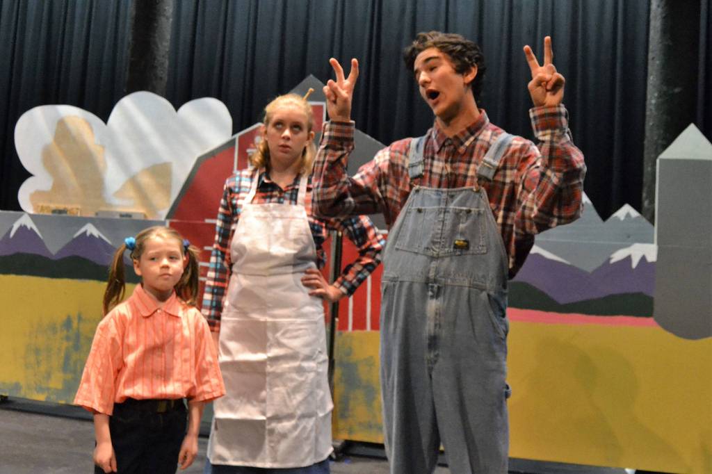 Charity (Maia Brewer) and her Mother (Emily McAliley) listen to Father (Ashton Drew) spin a yarn about the dragon he just saw. Sequim Gazette photo by Matthew Nash