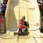 At left, 3-year-old Stormie Trevino, and Stephanie Trevino enjoy multiple rides on a slide at the Clallam County Fair carnival last week.