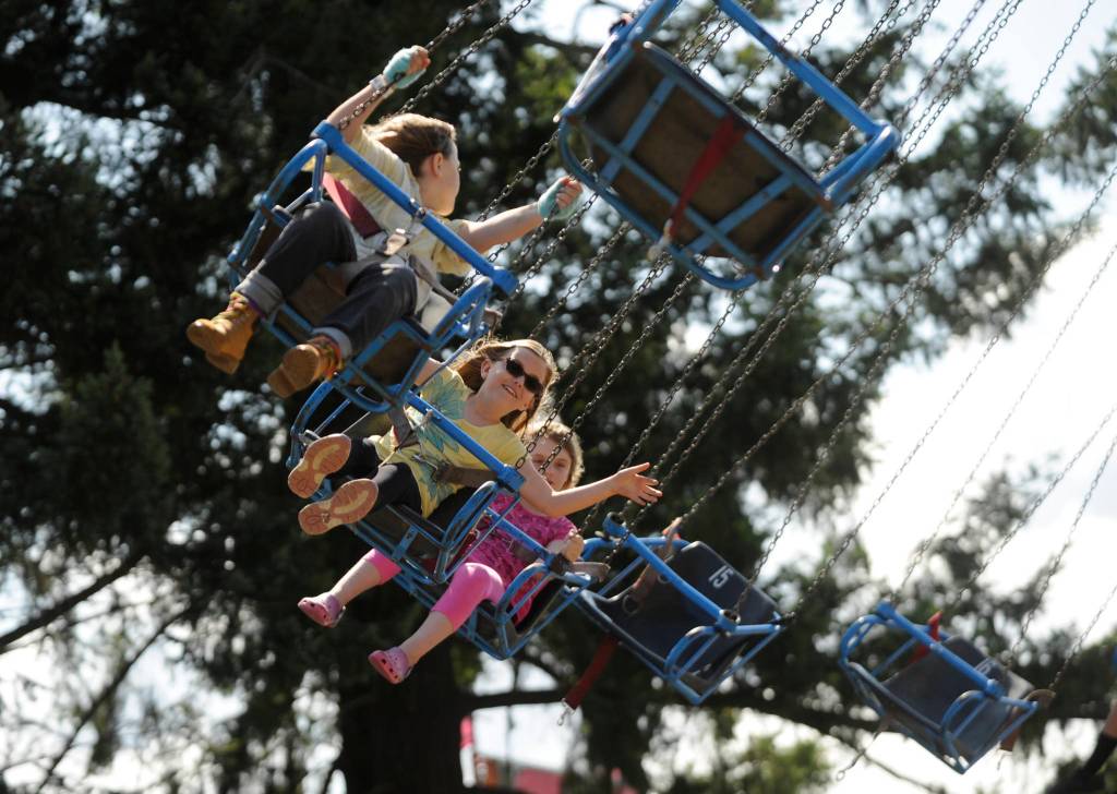 From left, Kiari Latson, 10, Mallory Hartman, 9, and Annelisa Rosenkranz, 8, enjoy a ride at the Clallam County Fair last week. Sequim Gazette photo by Michael Dashiell