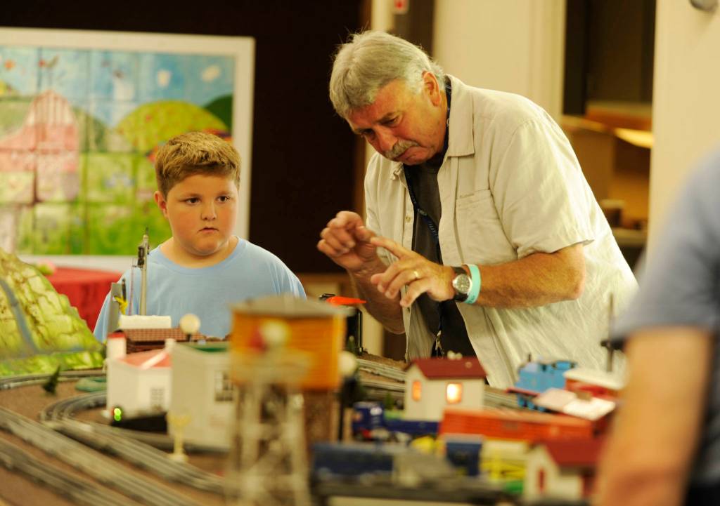 Nathaniel Baze, 7, at left, talks with Steve Dryke of the North Olympic Railroaders group at the Clallam County Fair last week. Sequim Gazette photo by Michael Dashiell