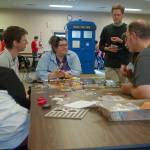 Several people from Sequim and Port Angeles work together to learn a new game at Opttacon 2019 at the Guy Cole Event Center on Aug. 17. Sequim Gazette photo by Conor Dowley