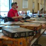 Jeff Tingelstad, organizer of Opttacon 2019, talks with an event attendee checking out a game to play during the convention. This is really what Opttacon is about, people checking out games they havent played and hanging out with fellow gamers to learn them, he said. Sequim Gazette photo by Conor Dowley