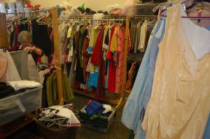 Former Sequim High School theater director Christy Rutherford helps organize the cleanout of the SHS theaters costume shop on Aug. 19. Weve never had a purge like this, said current director Ashley Kramer. We used to have four times this space, but we never got rid of anything. Kramer was helped by Rutherford and Sequim Middle School teacher David McInnes on Aug. 19 after a work party including theater students on Aug. 12 didnt get everything out. We still have a lot of work to do, but you can actually move around in here now, and see up and down the aisles, Rutherford said. Kramer said that the majority of the clothes taken out of the closet were donated to Goodwill, with some going to Sequim Serenity House. They were happy to take it all with Halloween coming up, Kramer said. Sequim Gazette photo by Conor Dowley