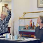Port of Port Angeles Commissioner Connie Beauvais displays a block of thermally modified hemlock that the port is participating in developing during a general election forum Tuesday that included her challenger, Marty Modine. Photo by Paul Gottlieb/Peninsula Daily News