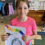 Lillian Sutherland shows off some artwork at the Sequim Boys & Girls Club last week.