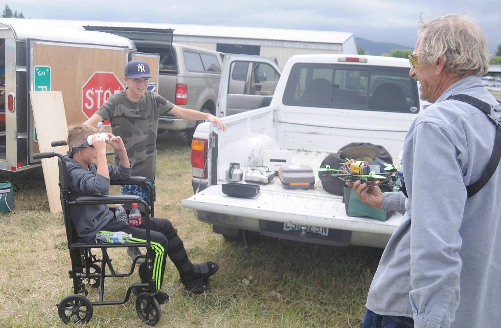 With brother Axel looking on, Magnus Asmundson (in chair) gets a virtual reality tour from Leland Cox of the Olympic R/C Modelers club at Saturdays Olympic Peninsula Air Affaire and Sequim Valley Fly-in. The Asmundsons, from Winnepeg, Manitoba (Canada), were in town visiting family.