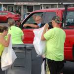 James Castell, right, works with other Castell Insurance staff and family members at the community shred event on Aug. 24. This event has definitely become a highlight of the year, Castell said. Its a lot of work, but it helps people who need their documents safely destroyed, and it helps a great organization (the Boys & Girls Club). Sequim Gazette photo by Conor Dowley