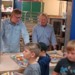 Washington State Reps. Mike Chapman, left, and Steve Tharinger, center, of the 24th legislative district serve lunch for the kids at the Boys & Girls Club in Sequim on Aug. 27. The club serves a free lunch to attendees and to families at several community locations every day during the summer. Sequim Gazette photos by Conor Dowley