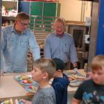 Washington State Reps. Mike Chapman, left, and Steve Tharinger, center, of the 24th legislative district serve lunch for the kids at the Boys & Girls Club in Sequim on Aug. 27. The club serves a free lunch to attendees and to families at several community locations every day during the summer. Sequim Gazette photos by Conor Dowley