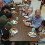 Tharinger, second from right, and Chapman, fifth from right, sit with unit director Dave Miller and numerous club kids. Tharinger and Chapman sat and talked with club kids for about half an hour before speaking in a brief assembly.