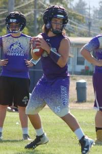 Sequim High School quarterback Taig Wiker drops back during offensive drills in an early practice session. I learned a lot from Riley, Wiker said of becoming the starting QB, and Im ready to take this on. Wiker starred as a running back last year, but Wolves head coach Erik Wiker said that his son had always played QB previously, and that he is excited to see his dynamism under center. Sequim Gazette photo by Conor Dowley