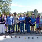 Mayor Dennis Smith cuts the ribbon for the new Bocce and shuffleboard courts on Aug. 28. The courts are free to use in Carrie Blake Community Park south of the Albert Haller Playfields. Sequim Gazette photo by Matthew Nash