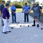 Players calculate scores for Bocce in the new court in Carrie Blake Community Park. Sequim Gazette photo by Matthew Nash