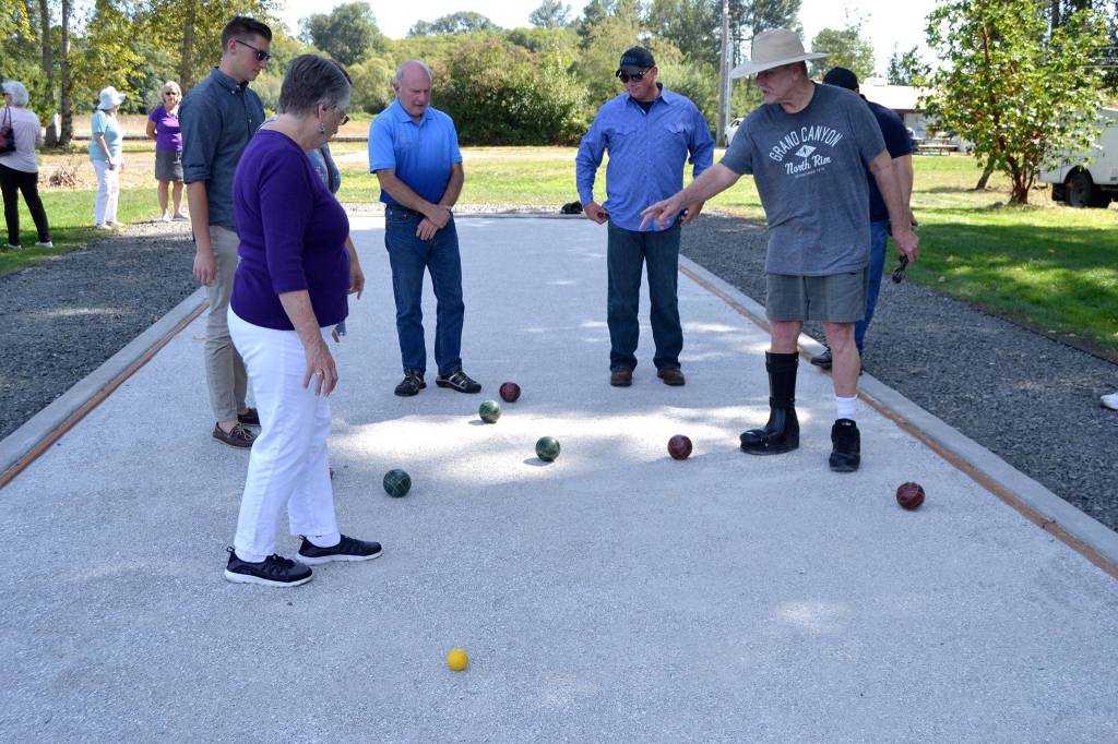 Players calculate scores for Bocce in the new court in Carrie Blake Community Park. Sequim Gazette photo by Matthew Nash