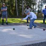 David Stahl rolls a bocce ball to help open play on the new court in Carrie Blake Community Park on Aug. 28. Sequim Gazette photo by Matthew Nash