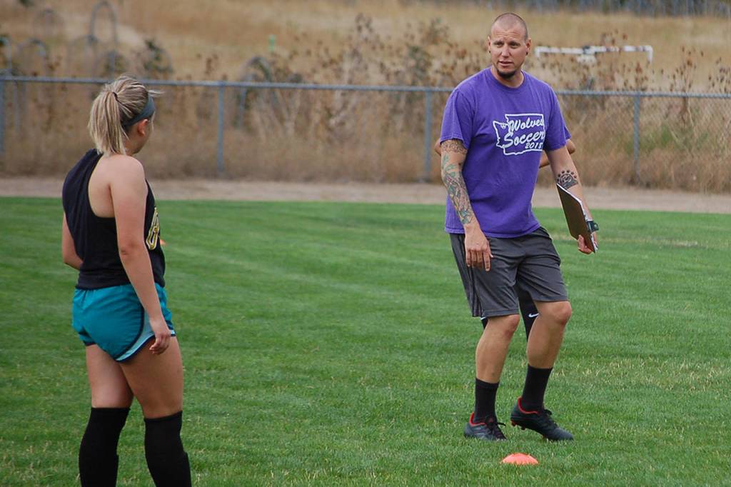 Head coach Derek Vander Velde gives tactical instructions to his players during a possession drill at a girls soccer practice this summer. Weve got a few new things that well be doing this season, he said. Sequim Gazette photo by Conor Dowley