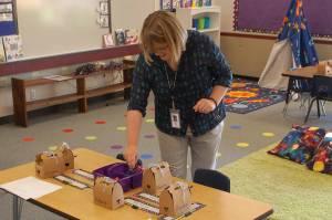 Greywolf Elementary School first grade teacher Kylie Douglas laughs as she puts together supplies on one of her students tables. Douglas is a new teacher at Greywolf, having taught in Tennessee before moving to the area in 2018, but will miss the first two weeks of the school year after undergoing back surgery on Sept. 4. This just reinforces for me that our substitutes are the real heroes of the school district, she said. Sequim Gazette photo by Conor Dowley