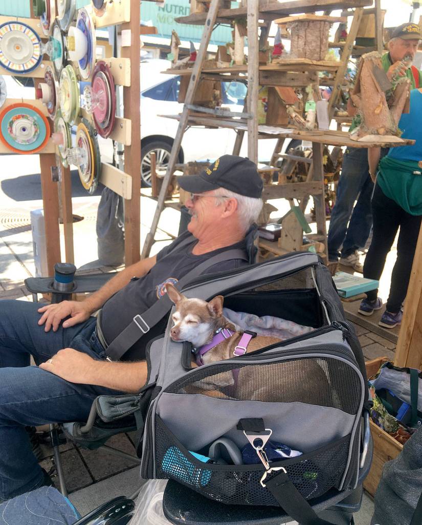 Jody Schroeder with Rain Lily and his pup enjoy a day at the market. Photo courtesy of April Hammerand/Sequim Farmers Market.