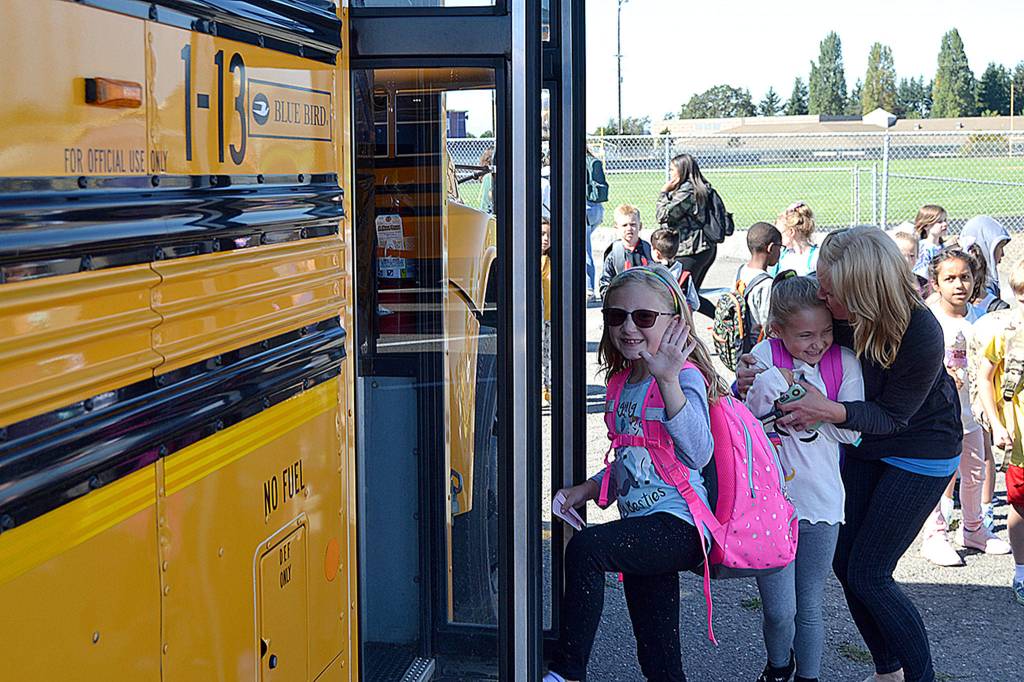Second grader Lillian Nesset steps onto the bus after school on Sept. 4. She and hundreds of other Sequim students started school last week while area kindergartners started on Sept. 9. Sequim Gazette photo by Matthew Nash