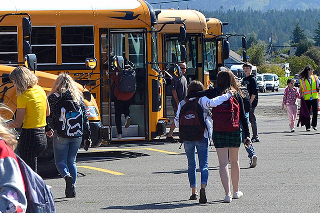 Aaron Reno and son Jude celebrate Judes first day of kindergarten at Greywolf Elementary on Sept. 4. Photo by Darcy Lamb                                 Friends walk to their bus at the end of the first day of school on Sept. 4. Sequim Gazette photo by Matthew Nash