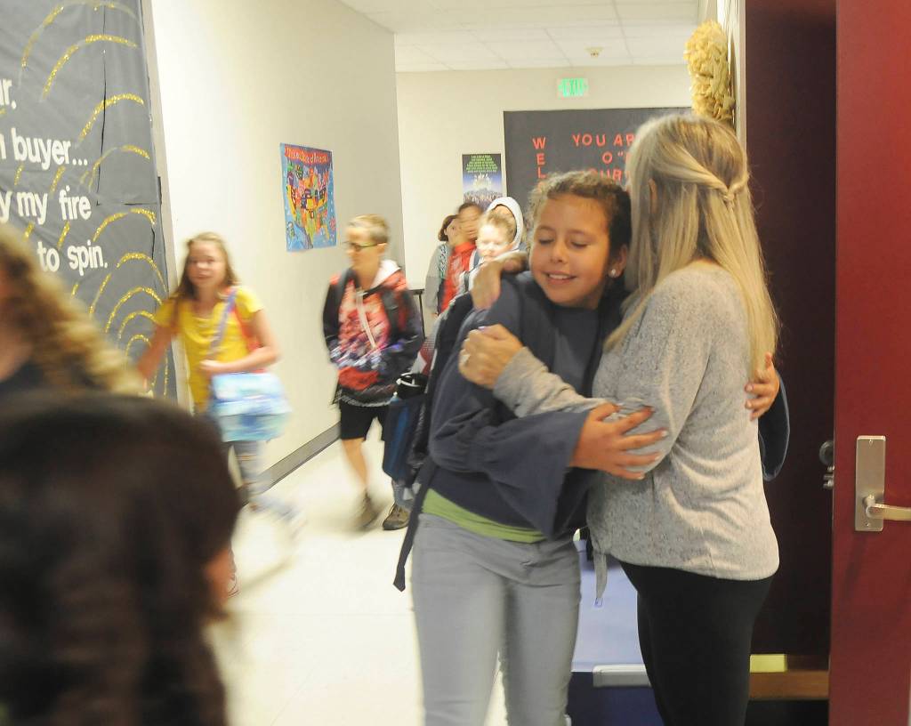 Fifth-grader Ryhen Bidasha gets a hug from teacher Sheri Burke on the first day of class at Greywolf Elementary School in Carlsborg. Sequim Gazette photo by Michael Dashiell