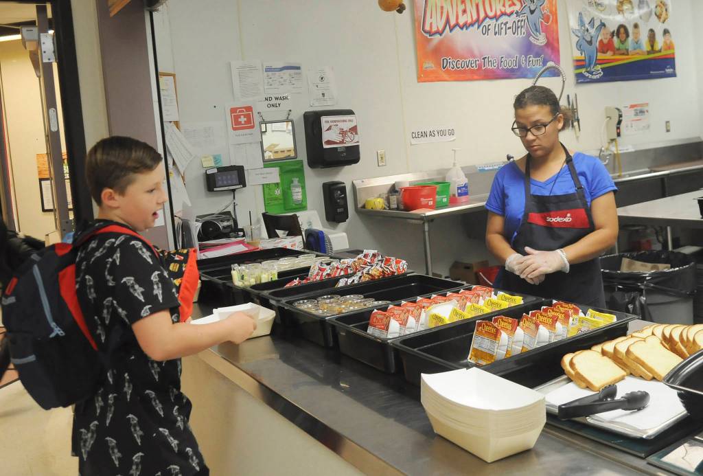 Greywolf student Jasper Flath talks with Alyssa Stratton of Sodexo on the first day ofschool at Greywolf Elementary. Sequim Gazette photo by Michael Dashiell