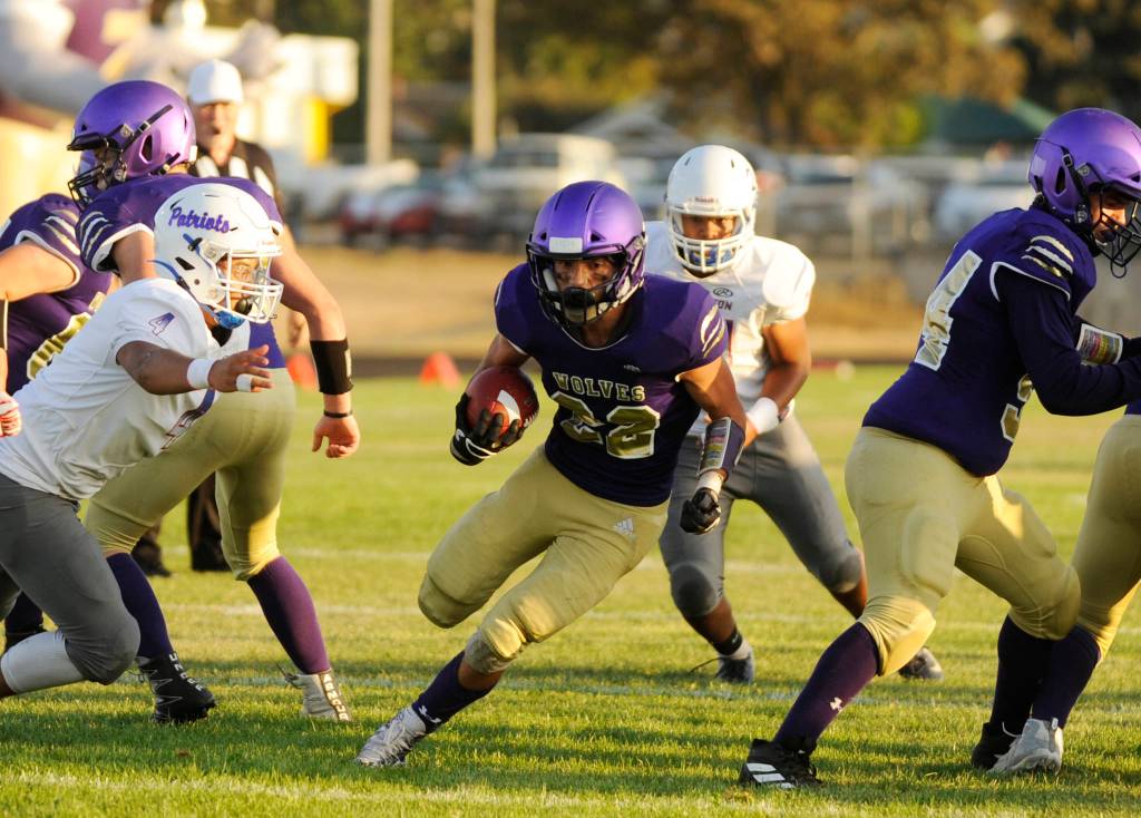 Sequim running back Walker Ward crossed the goalline for a touchdown in the first quarter of the Wolves non-league game against Washington on Sept. 6. Sequim Gazette photo by Michael Dashiell